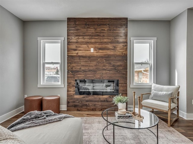 interior space with plenty of natural light, wood finished floors, and baseboards