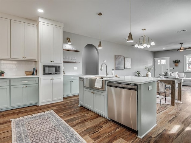 kitchen with black microwave, light countertops, and dishwasher