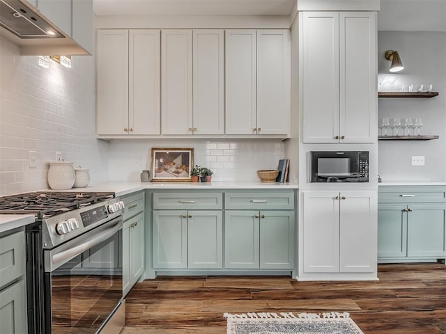 kitchen with light countertops, tasteful backsplash, stainless steel gas range, and dark wood-style flooring