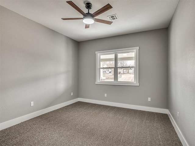 empty room with carpet, visible vents, ceiling fan, and baseboards