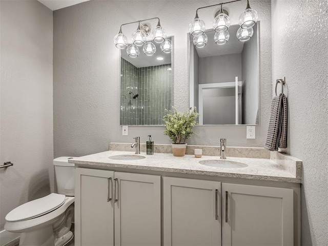 bathroom featuring toilet, a sink, and a textured wall