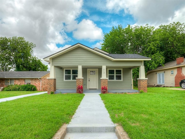 1413 NE 14th St, Oklahoma City, OK 73117 - craftsman house with a front yard and covered porch