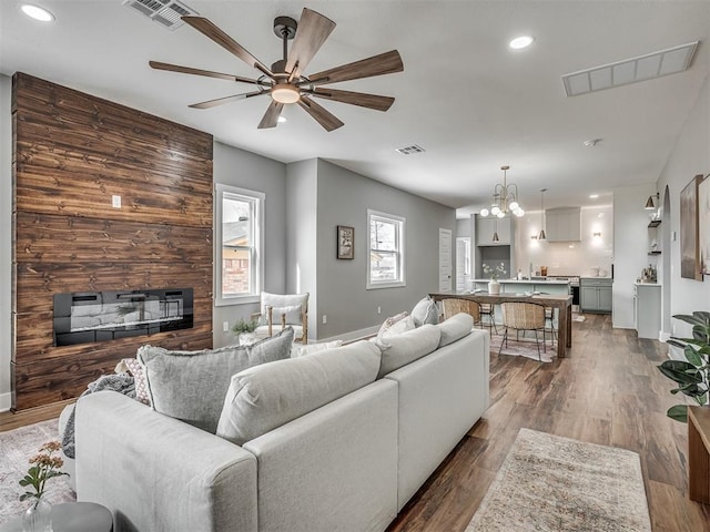 1413 NE 14th St, Oklahoma City, OK 73117 - living area with a large fireplace, recessed lighting, ceiling fan, baseboards, and wood finished floors