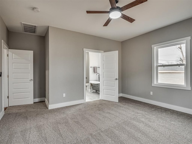 1413 NE 14th St, Oklahoma City, OK 73117 - unfurnished bedroom with baseboards, carpet flooring, and ensuite bath
