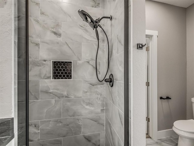 1413 NE 14th St, Oklahoma City, OK 73117 - full bathroom featuring a stall shower, toilet, and baseboards