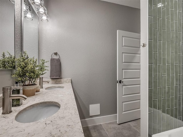 1413 NE 14th St, Oklahoma City, OK 73117 - full bath featuring double vanity, tile patterned floors, baseboards, and a shower