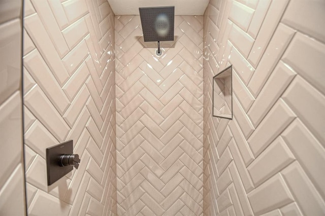 interior details featuring tiled shower