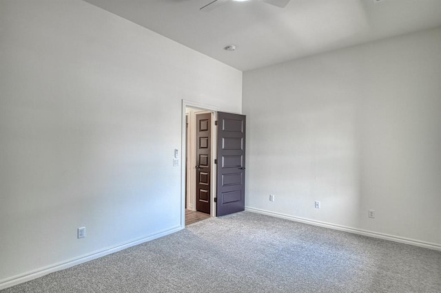 unfurnished room with baseboards, carpet, and a ceiling fan