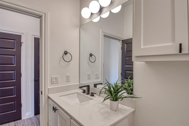 bathroom with wood finished floors and vanity