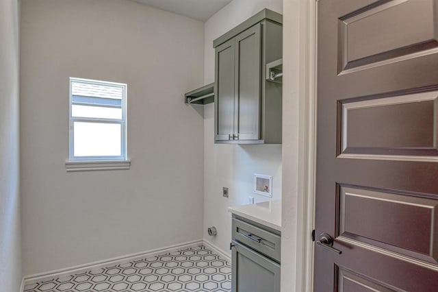 laundry area with cabinet space, hookup for an electric dryer, baseboards, and washer hookup