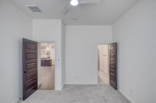 unfurnished bedroom featuring visible vents, baseboards, and carpet