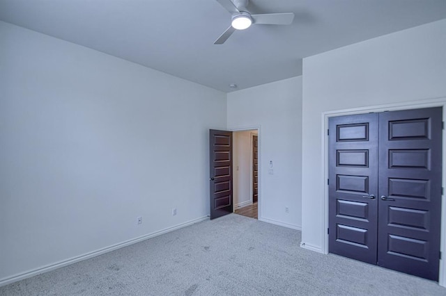 unfurnished bedroom featuring a closet, baseboards, ceiling fan, and carpet flooring