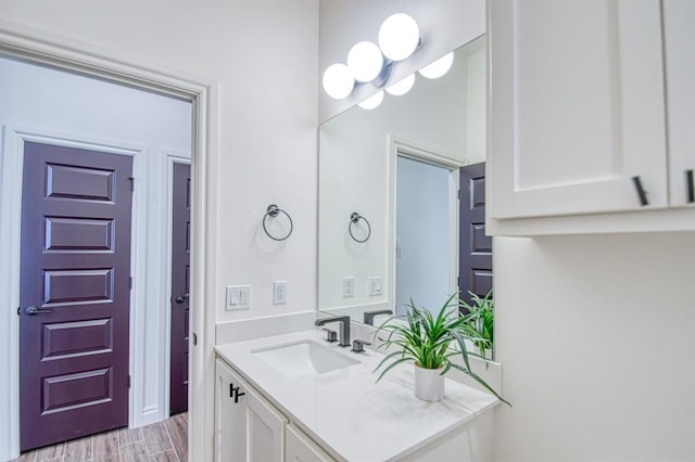 bathroom featuring wood finished floors and vanity