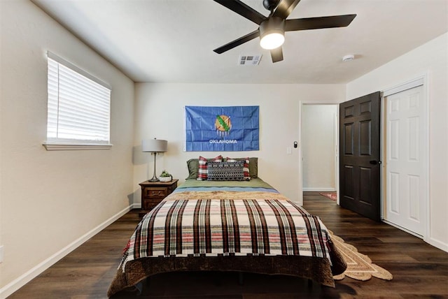 bedroom with baseboards, visible vents, ceiling fan, and wood finished floors