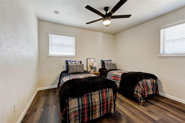 bedroom featuring a ceiling fan, baseboards, and wood finished floors