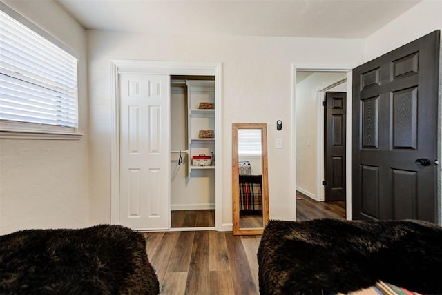 bedroom with a closet and wood finished floors