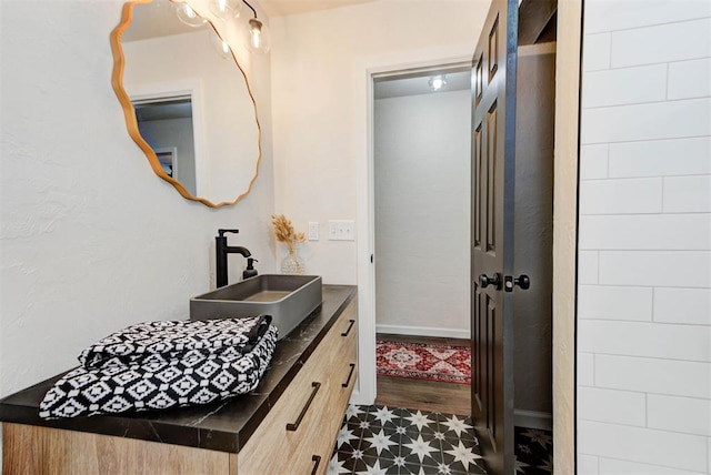 bathroom featuring baseboards and vanity