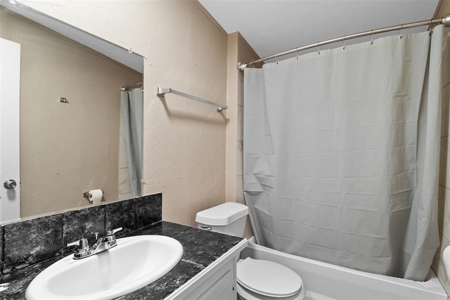 full bathroom with toilet, a textured wall, shower / bath combination with curtain, and vanity