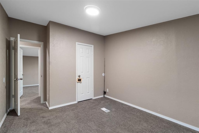 unfurnished bedroom featuring carpet and baseboards