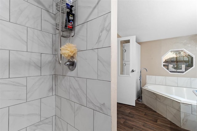 full bathroom with wood finished floors, a tile shower, and a bath