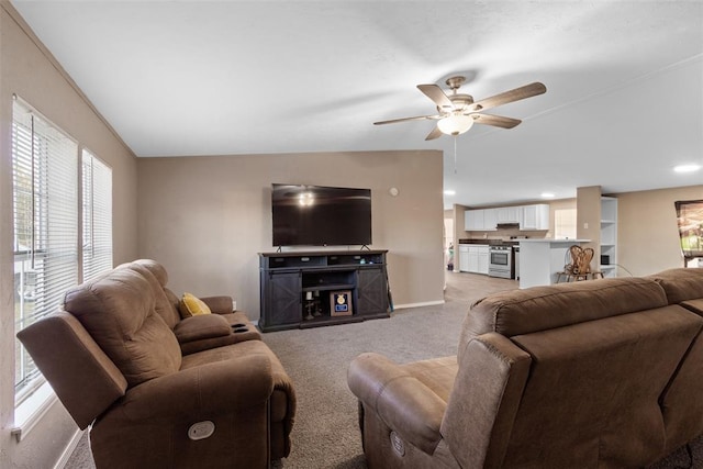 living area featuring recessed lighting, light carpet, ceiling fan, and baseboards