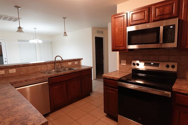 2841 NW 184th Ter, Edmond, OK 73012 - kitchen with stainless steel appliances, visible vents, a sink, and decorative backsplash