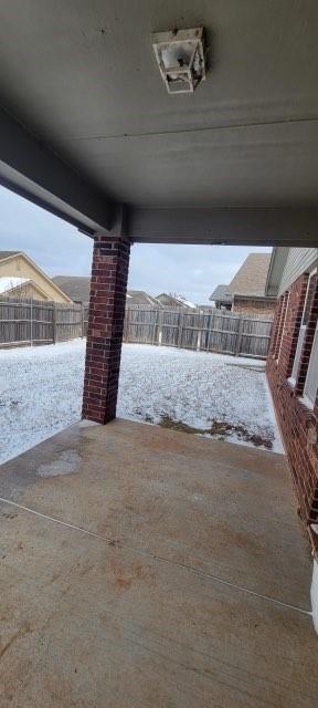 2841 NW 184th Ter, Edmond, OK 73012 - snow covered patio featuring a fenced backyard