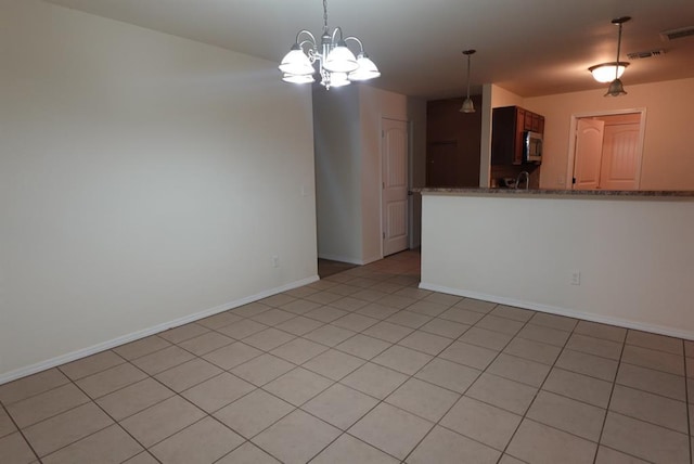 2841 NW 184th Ter, Edmond, OK 73012 - unfurnished room with baseboards, visible vents, and an inviting chandelier