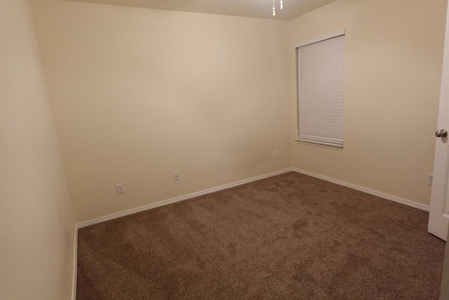 2841 NW 184th Ter, Edmond, OK 73012 - spare room featuring baseboards and dark carpet