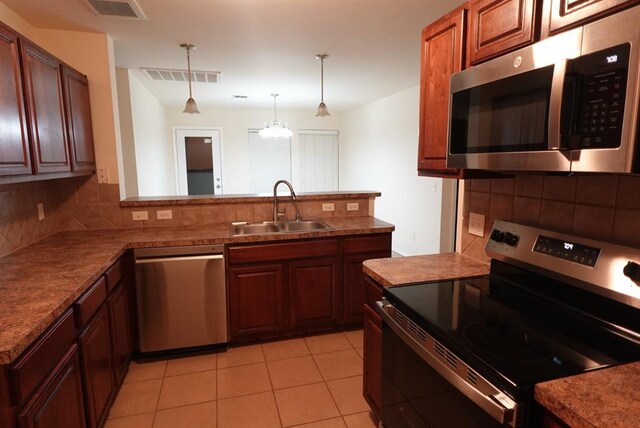 2841 NW 184th Ter, Edmond, OK 73012 - kitchen with stainless steel appliances, visible vents, a sink, and hanging light fixtures