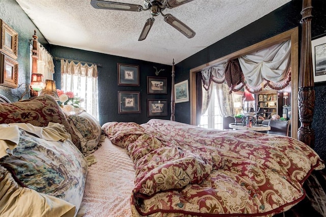 bedroom with access to outside, a textured ceiling, and a ceiling fan