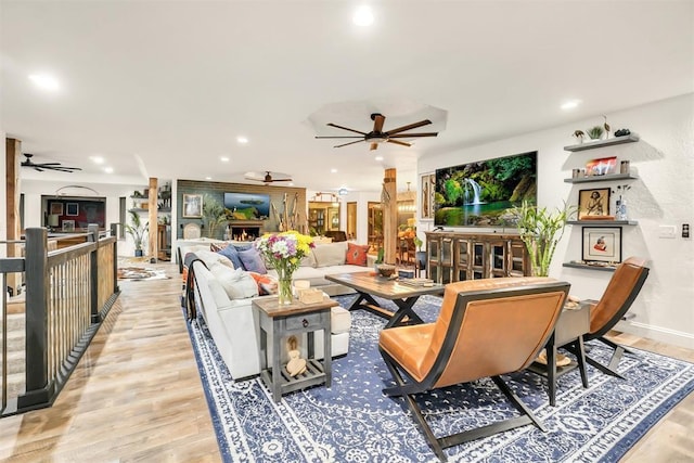 living room featuring ceiling fan and light wood-type flooring