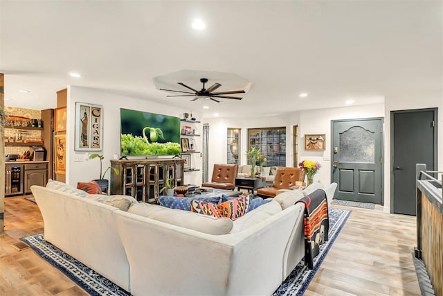 living room with light hardwood / wood-style floors and ceiling fan