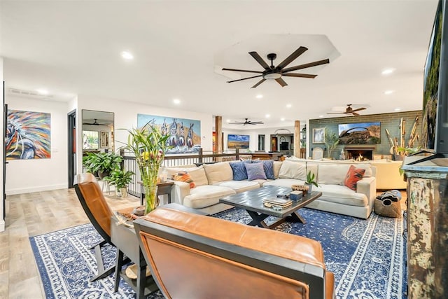 living room featuring ceiling fan and light hardwood / wood-style floors