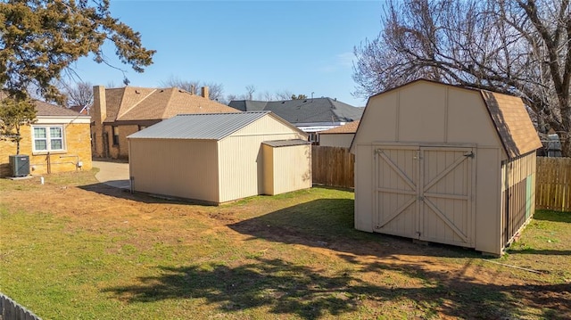 view of shed featuring a fenced backyard and central AC unit