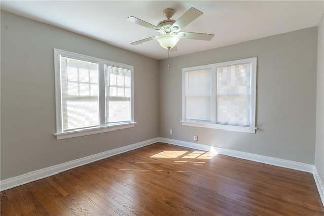 empty room with ceiling fan, baseboards, and wood finished floors