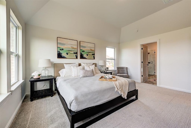 carpeted bedroom featuring ensuite bathroom and lofted ceiling