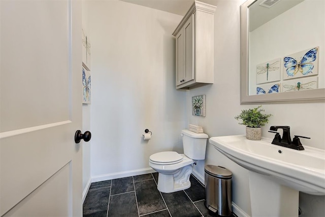 bathroom with tile patterned floors, sink, and toilet