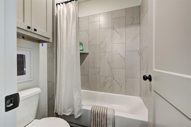 bathroom with toilet and shower / bath combo