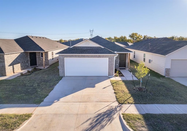 single story home featuring brick siding, an attached garage, driveway, and a front yard