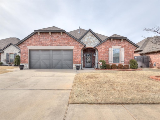 view of front of home with a front lawn and a garage