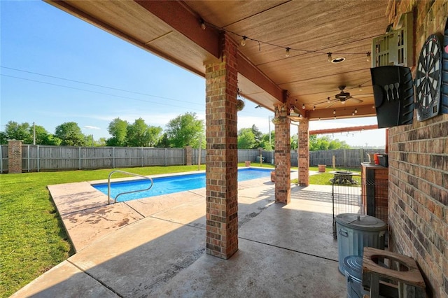 4220 Caribou St, Tuttle, OK 73089 - view of pool featuring a fenced in pool, a fenced backyard, a patio area, a ceiling fan, and a yard