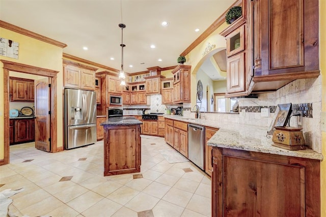4220 Caribou St, Tuttle, OK 73089 - kitchen featuring a center island, ornamental molding, stainless steel appliances, and a sink