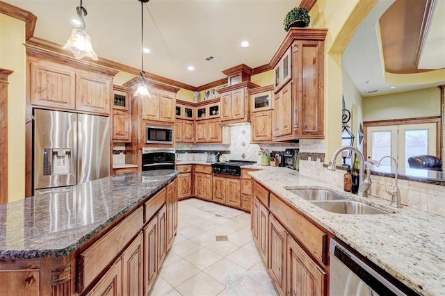 4220 Caribou St, Tuttle, OK 73089 - kitchen featuring dark stone countertops, light tile patterned floors, a sink, decorative backsplash, and black appliances