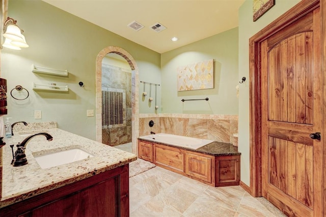 4220 Caribou St, Tuttle, OK 73089 - full bathroom with a bath, visible vents, vanity, and tiled shower