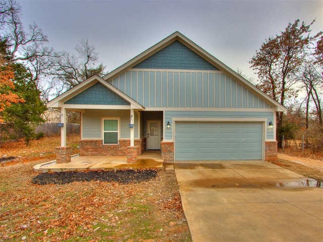 craftsman inspired home featuring covered porch and a garage