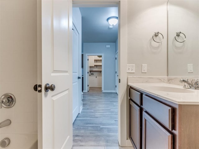 bathroom featuring vanity, tiled shower / bath, and hardwood / wood-style floors