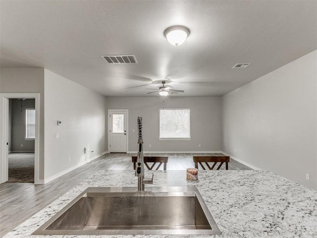 interior space featuring ceiling fan, sink, and light hardwood / wood-style floors