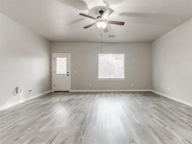 empty room featuring light wood-type flooring and ceiling fan