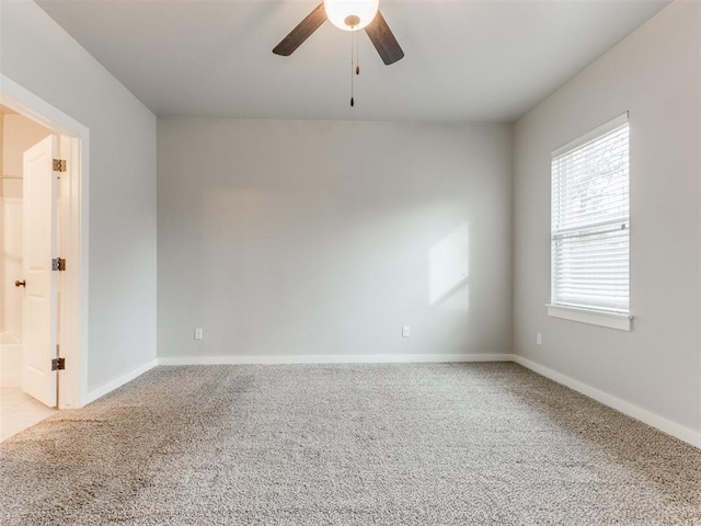 spare room with ceiling fan and carpet floors